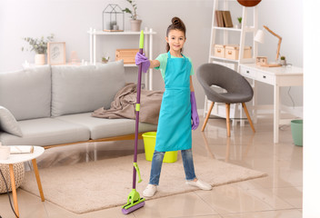 Little housewife cleaning floor at home