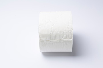 Symbol image for corona crisis panic buying / hoarding. Roll of toilet paper on white Background,...