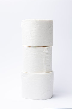 Symbol image for corona crisis panic buying / hoarding. Pile of toilet paper on white Background, with copy space.