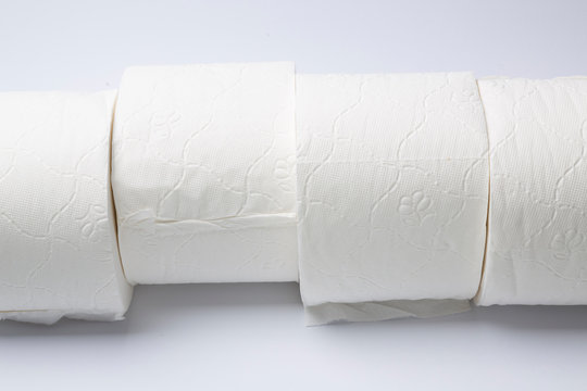 Symbol image for corona crisis panic buying / hoarding. Rolls of toilet paper on white Background, with copy space.