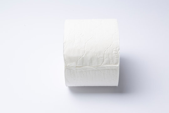 Symbol image for corona crisis panic buying / hoarding. Roll of toilet paper on white Background, with copy space.