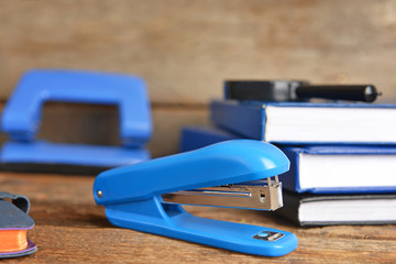 Blue stapler on wooden table