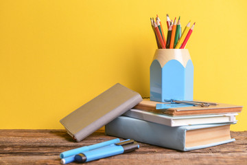 Fototapeta premium Set of school supplies on table against color background