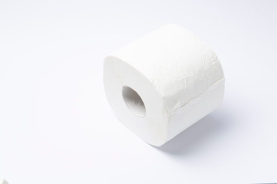 Symbol image for corona crisis panic buying / hoarding. Roll of toilet paper on white Background, with copy space.