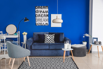 Interior of modern living room with blue wall