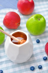 Tasty honey with fruits on table