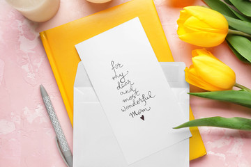 Composition with greeting card for mother on color background