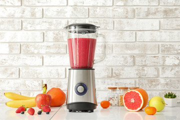Blender with ingredients for healthy smoothie on kitchen table