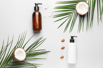 Composition with shampoo, almond and coconut on white background