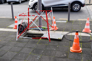 Open manhole with few cables connection internet using fiber optic