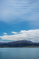 Beautiful river with snowy mountains in the background taken on a sunny day, New Zealand