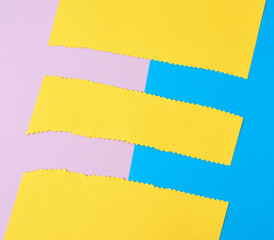 abstract background of colored paper, yellow stripes with a zigzag end