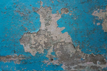 Old blue paint peeling on concrete wall, abstract background, Selective focus 