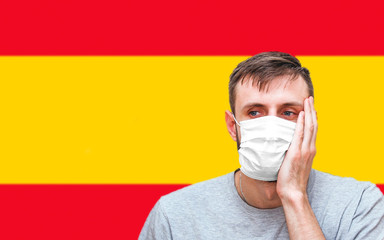 man in medical mask on his face, which protects against coronavirus and other diseases, holds his...