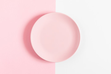 Pink kitchen background. Food concept. Pink plate on pastel pink and white background. Flat lay, top view, copy space. 