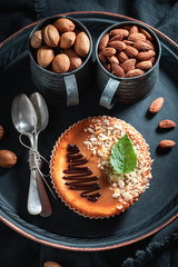 Brown and homemade cheesecake with almonds made nuts and chocolate