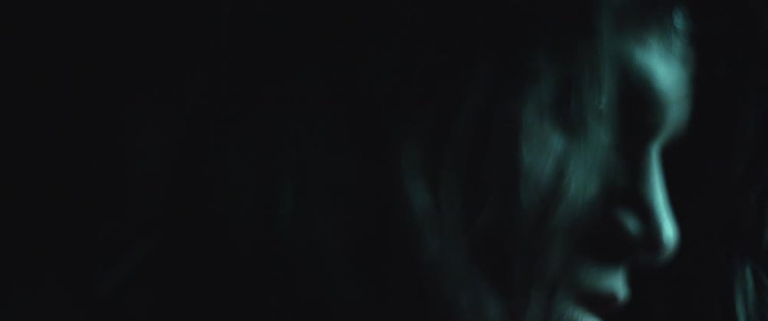 Terrifying creepy zombie woman with white eyes and bloody face. Scary look. Woman transformation into zombie concept. Horror style shot. Close up, slow motion, cinematic look. BMPCC 4K