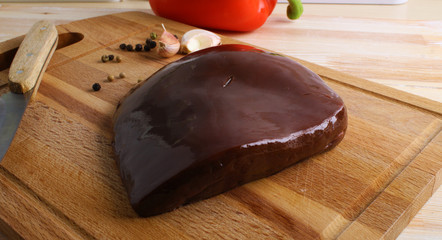 Beef liver on a wooden background