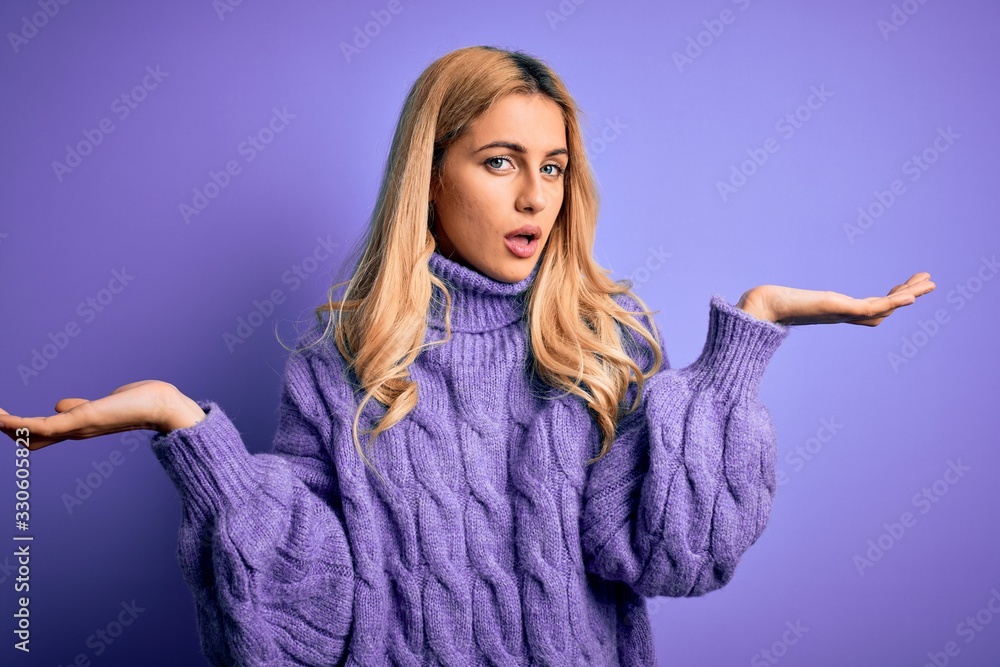 Poster young beautiful blonde woman wearing casual turtleneck sweater over purple background clueless and c