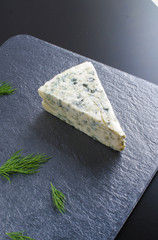 blue cheeseon a dark stone background