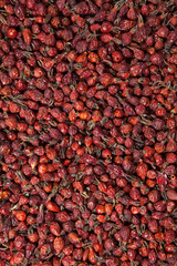 Dried rosehip berries. Used for design, websites, interior, background backdrop texture creation. Healthy natural vitamin berries for tea. Natural medical antioxidant. Top view. Closeup