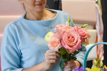Flowers a hobby. Female florist making a floral arrangement. Caring for cut flowers