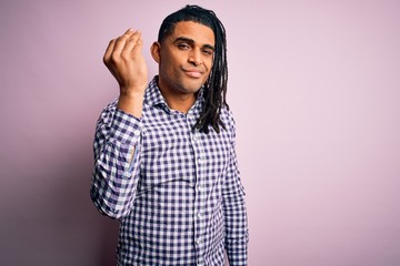 Fototapeta premium Young handsome african american afro man with dreadlocks wearing casual shirt Doing Italian gesture with hand and fingers confident expression