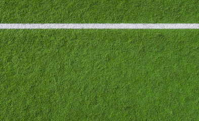 White line marking on green turf of a sports field