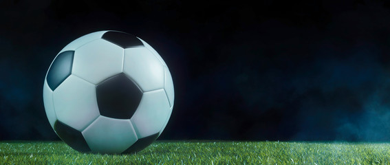 Traditional football on an illuminated sports field at night