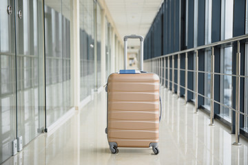 Suitcases in airport departure lounge, summer vacation concept, traveler suitcases in airport terminal waiting area, empty hall interior with large windows. luggage on airport terminal background.