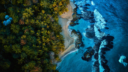 Magnificent aerial shot of a blue tropic lagoon with crystal clear water surrounded by beach and...