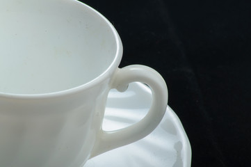 white cup on black background