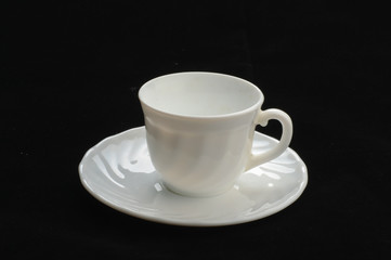 white cup on black background