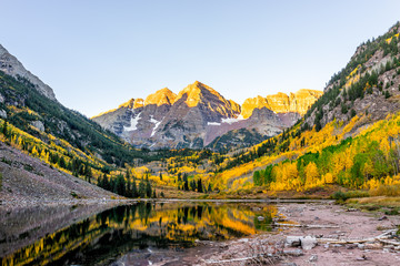 Maroon Bells lake at sunrise sunlight in Aspen, Colorado with rocky mountain peak and snow in...