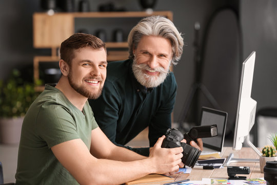 Mentor teaching young photographer in studio