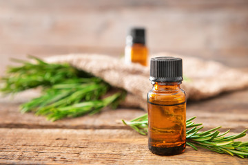 Bottle of rosemary essential oil on table