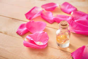 Obraz na płótnie Canvas Bottle of rose essential oil on table