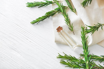 Bottle of rosemary essential oil on table