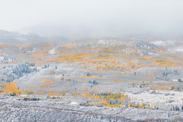 Aspen, Colorado USA rocky mountains aerial high angle view of blizzard in autumn 2019 and yellow trees foliage in roaring fork valley hillside