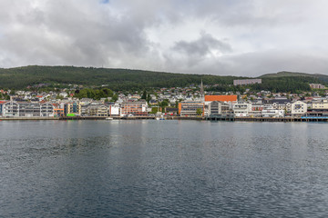 Fototapeta na wymiar Norway - June 14, 2016: view of a small town from the deck of ships, selective focus.