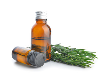 Bottles of rosemary essential oil on white background