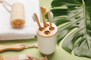 Tooth brushes with bath supplies on color background