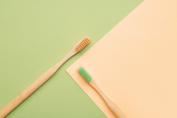Wooden tooth brushes on color background