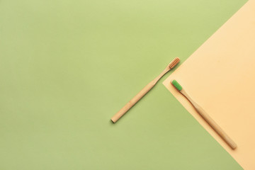 Wooden tooth brushes on color background
