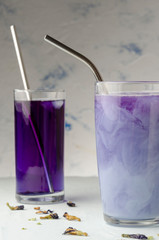 Glass of iced Butterfly Pea latte or blue Anchan flower tea with