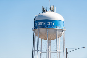 View of water tower sign for Garden City in Kansas countryside industrial town closeup isolated against sky - obrazy, fototapety, plakaty