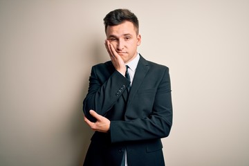 Young handsome business man wearing elegant suit and tie over isolated background thinking looking...