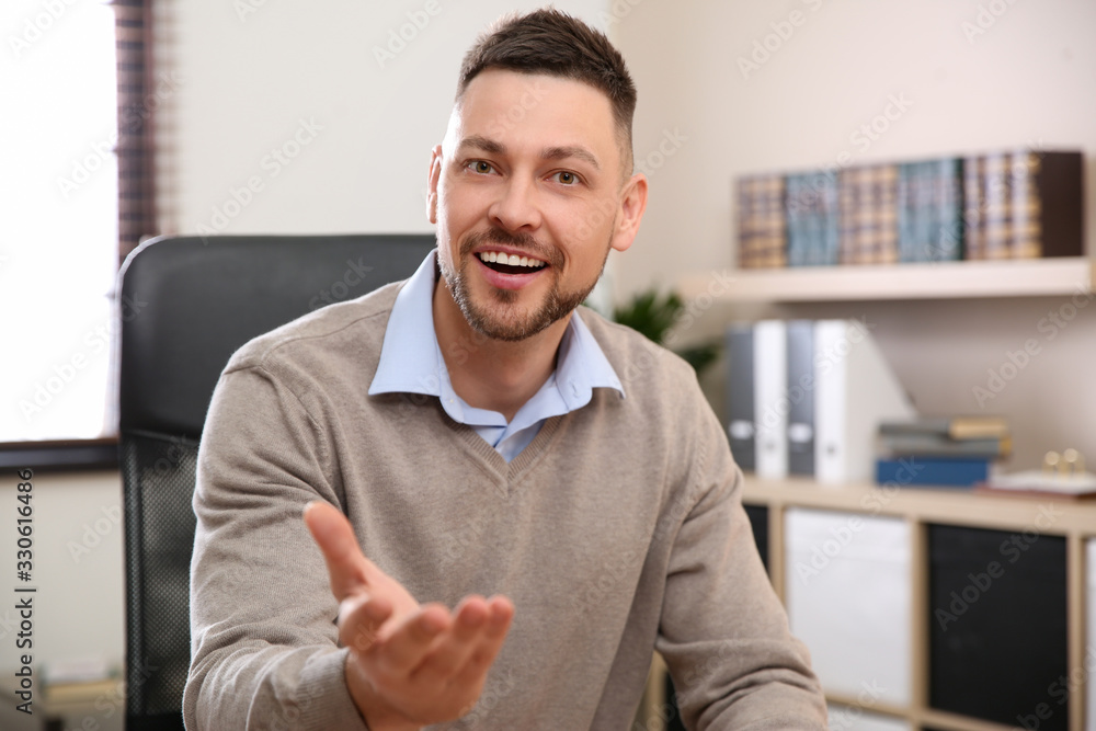 Poster man using video chat in office, view from web camera
