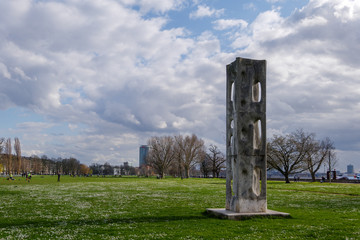 Outdoor sunny view of sculpture at  Rheinpark Golzheim, big long park along riverside of Rhine river in Düsseldorf, Germany with background of overcast sky.
