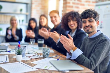 Group of business workers smiling happy and confident. Working together with smile on face looking at the camera applauding at the office
